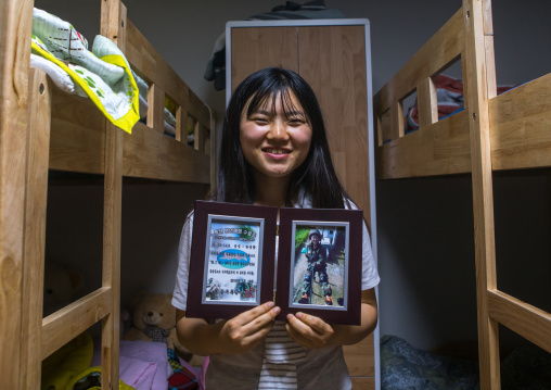 North korean teen defector showing an army training diploma, National capital area, Seoul, South korea