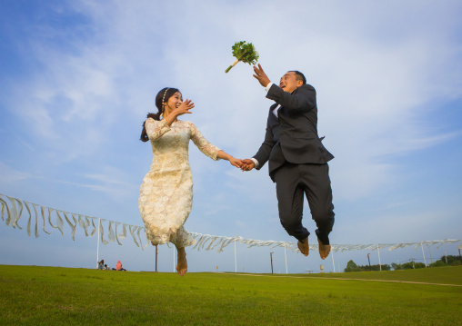 North korean defector joseph park with his south korean fiancee called juyeon jumping in imjingak park, Sudogwon, Paju, South korea