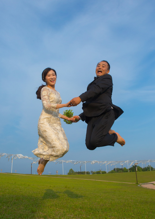 North korean defector joseph park with his south korean fiancee called juyeon jumping in imjingak park, Sudogwon, Paju, South korea