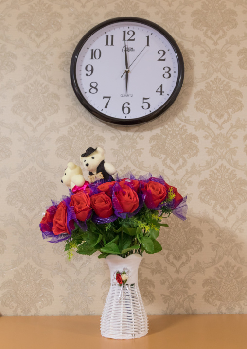 Clock an plastic flowers during the exhibition Pyongyang sallim at architecture biennale showing a north Korean apartment replica, National Capital Area, Seoul, South Korea