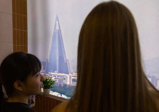 South Korean visitors looking thru a fake balcony during the exhibition Pyongyang sallim at architecture biennale showing a north Korean apartment replica, National Capital Area, Seoul, South