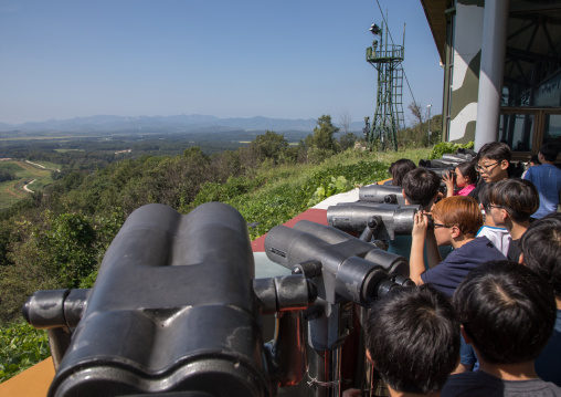 Children using binoculars in front of freedom and railway bridge over Imjin river between north and south Korea, North Hwanghae Province, Panmunjom, South Korea