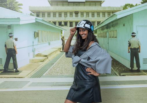 Tourist posing in front of a giant picture of the DMZ border, North Hwanghae Province, Panmunjom, South Korea