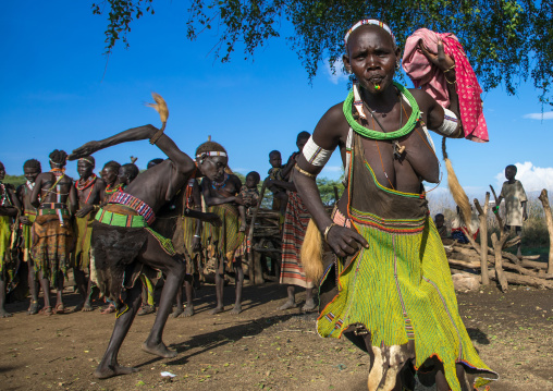 Toposa tribe women in traditional clothing dancing during a ceremony, Namorunyang State, Kapoeta, South Sudan