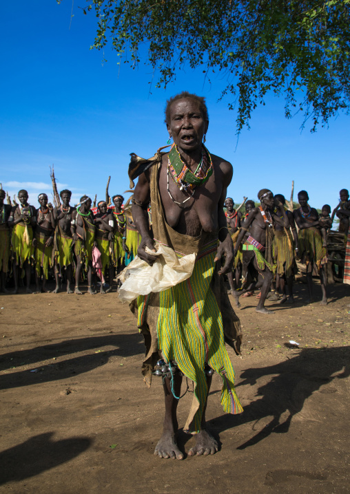 Toposa tribe woman in traditional clothing dancing during a ceremony, Namorunyang State, Kapoeta, South Sudan