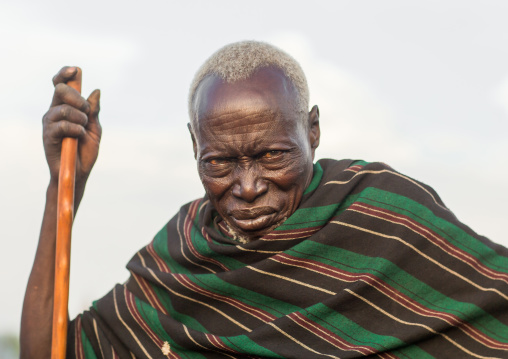 Toposa tribe senior man with a wood stick, Namorunyang State, Kapoeta, South Sudan