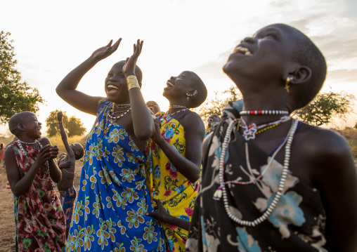 Toposa tribe women in traditional clothing looking at the sky, Namorunyang State, Kapoeta, South Sudan