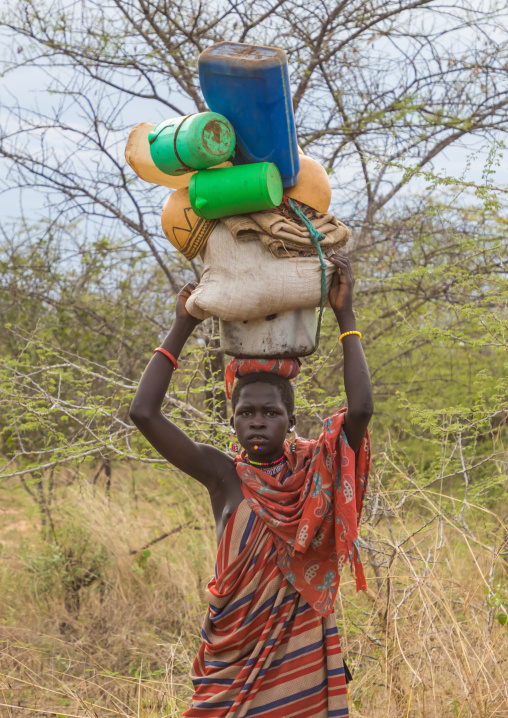 Larim tribe woman carrying heavy stuff on her head, Boya Mountains, Imatong, South Sudan