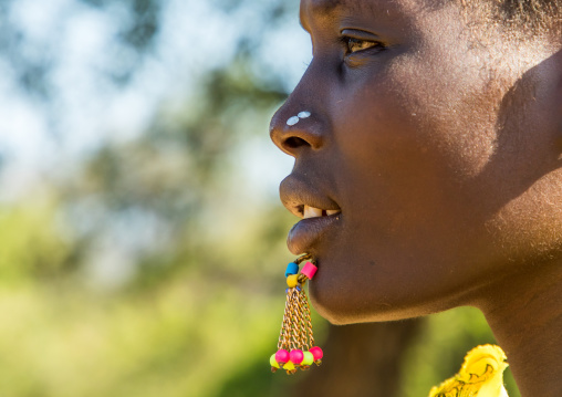 Close up of the face of a Larim tribe woman with a chin labret, Boya Mountains, Imatong, South Sudan