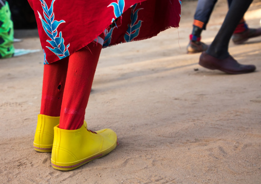 Larim tribe woman with yellow shoes dancing during a wedding celebration, Boya Mountains, Imatong, South Sudan