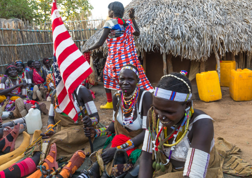 Larim tribe women with an american flag during a wedding celebration, Boya Mountains, Imatong, South Sudan