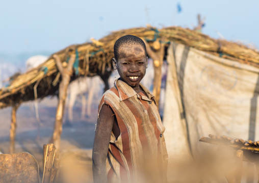 Smiling Mundari tribe boy covered in ash to repel flies and mosquitoes in a cattle camp, Central Equatoria, Terekeka, South Sudan