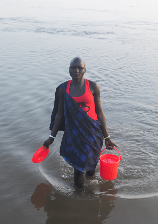 Mundari tribe woman collecting water in the river Nile, Central Equatoria, Terekeka, South Sudan