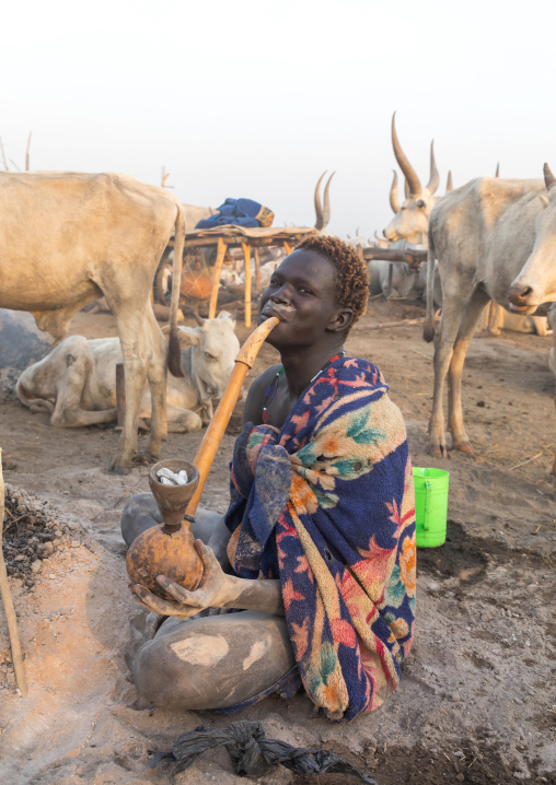 Mundari tribe man smoking with a pipe made with a calabash, Central Equatoria, Terekeka, South Sudan