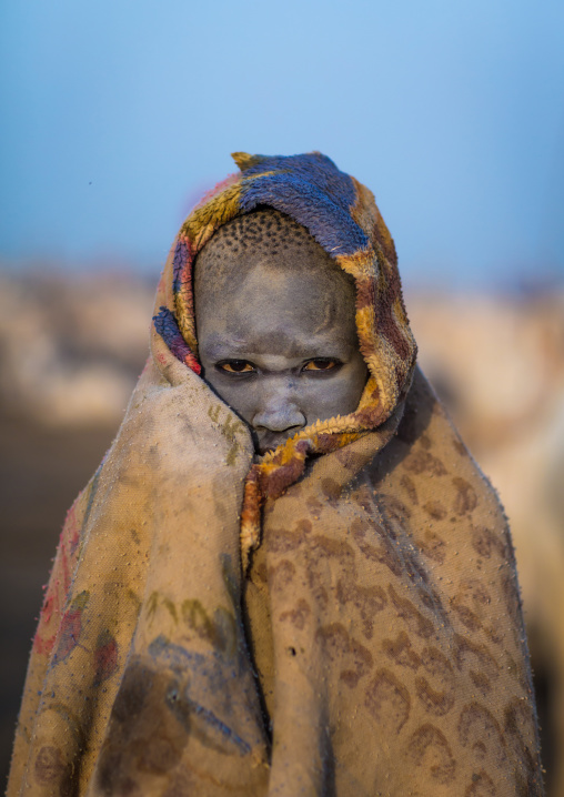 A Mundari tribe boy wrapped in blanket to fight the cold in a cattle camp, Central Equatoria, Terekeka, South Sudan