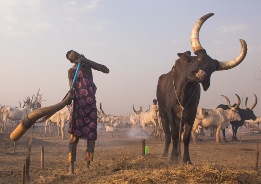 Mundari tribe man blowing in a cow horn, Central Equatoria, Terekeka, South Sudan