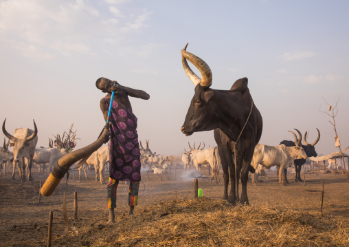 Mundari tribe man blowing in a cow horn, Central Equatoria, Terekeka, South Sudan