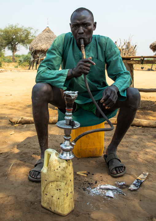 Mundari tribe man smoking shisha, Central Equatoria, Terekeka, South Sudan