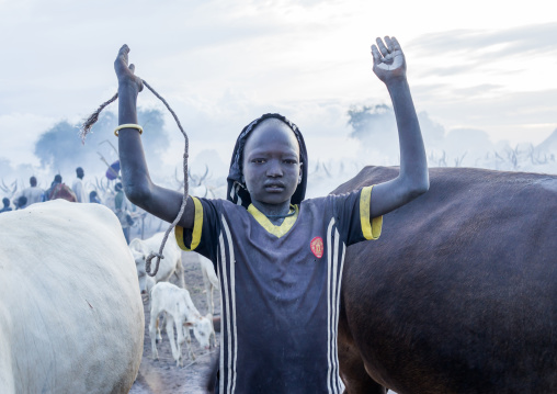 A Mundari tribe man mimics the position of horns of his favourite cow, Central Equatoria, Terekeka, South Sudan