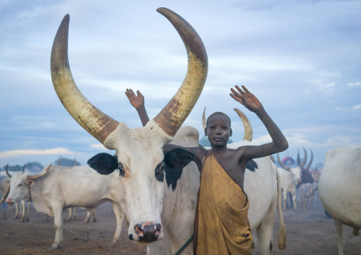 A Mundari tribe boy mimics the position of horns of his favourite cow, Central Equatoria, Terekeka, South Sudan