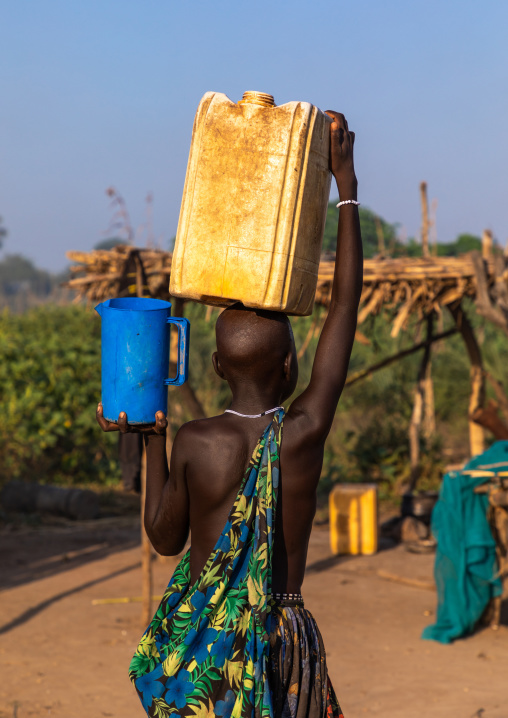 Mundari tribe woman carrying a yellow jerrican on the head, Central Equatoria, Terekeka, South Sudan