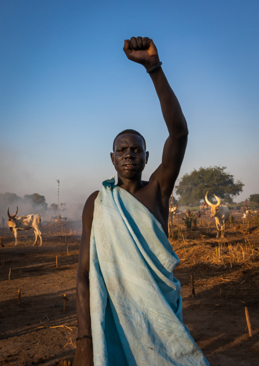 A Mundari tribe man mimics the position of horns of his favourite cow, Central Equatoria, Terekeka, South Sudan