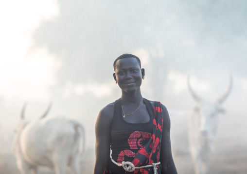 Mundari tribe woman with long horns cows in a camp, Central Equatoria, Terekeka, South Sudan