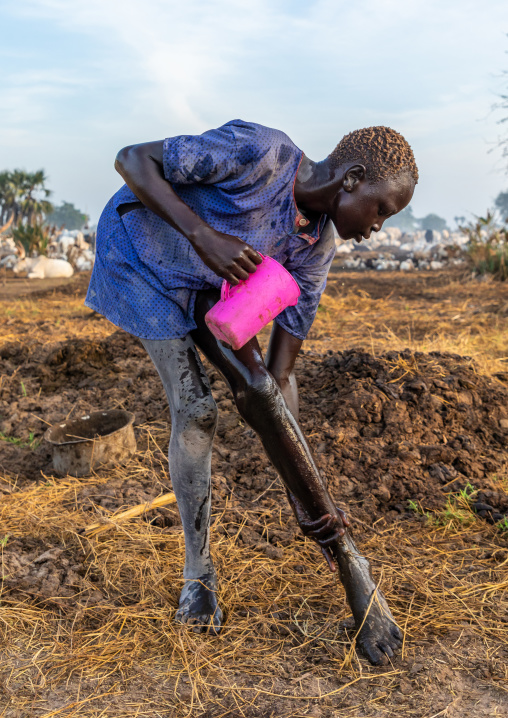 Mundari tribe boy showering with cow urine to take advantage of the antibacterial properties, Central Equatoria, Terekeka, South Sudan