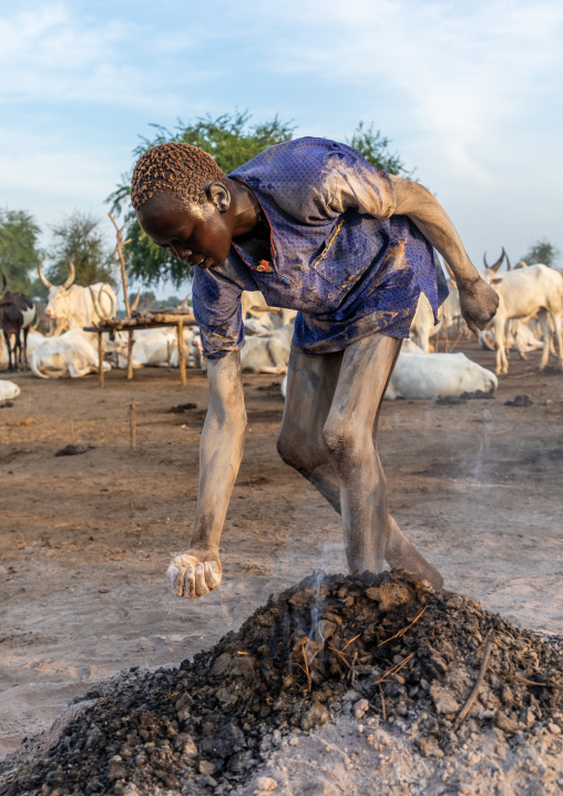 Mundari tribe man putting ash on his body after showering with cow urine, Central Equatoria, Terekeka, South Sudan