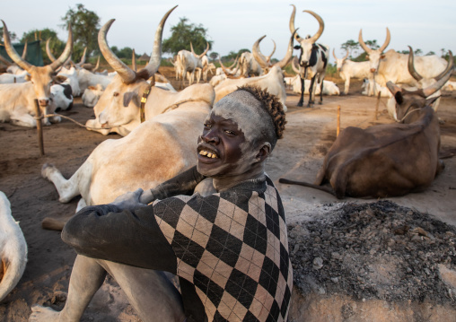 Mundari tribe boy taking care of the long horns cows in the camp, Central Equatoria, Terekeka, South Sudan