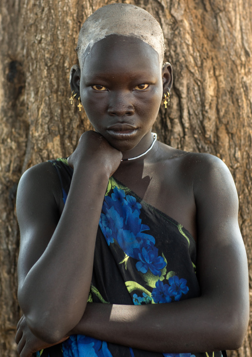 Portrait of a beautiful Mundari young woman with ash on the head to dye her hair in red, Central Equatoria, Terekeka, South Sudan