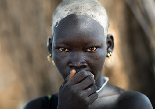 Portrait of a beautiful Mundari young woman with ash on the head to dye her hair in red, Central Equatoria, Terekeka, South Sudan