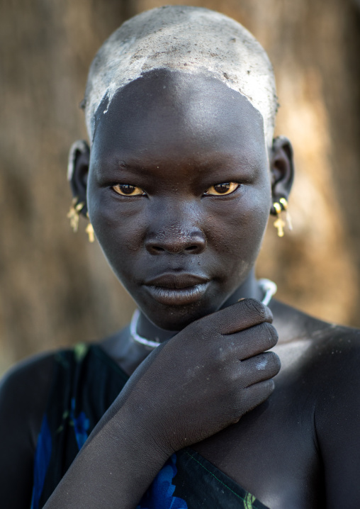 Portrait of a beautiful Mundari young woman with ash on the head to dye her hair in red, Central Equatoria, Terekeka, South Sudan