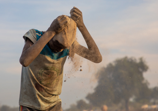 Mundari tribe boy covering his face in ash to protect from the mosquitoes and flies bites, Central Equatoria, Terekeka, South Sudan