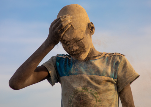 Mundari tribe boy covering his face in ash to protect from the mosquitoes and flies bites, Central Equatoria, Terekeka, South Sudan