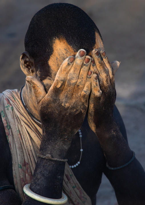 Mundari tribe man covering his body in ash to repel flies and mosquitoes, Central Equatoria, Terekeka, South Sudan