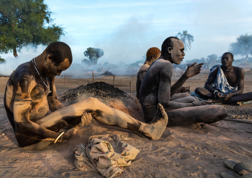 Mundari tribe men covering their bodies in ash to protect from the mosquitoes and flies bites, Central Equatoria, Terekeka, South Sudan