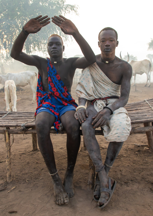 A Mundari tribe man mimics the position of horns of his favourite cow, Central Equatoria, Terekeka, South Sudan