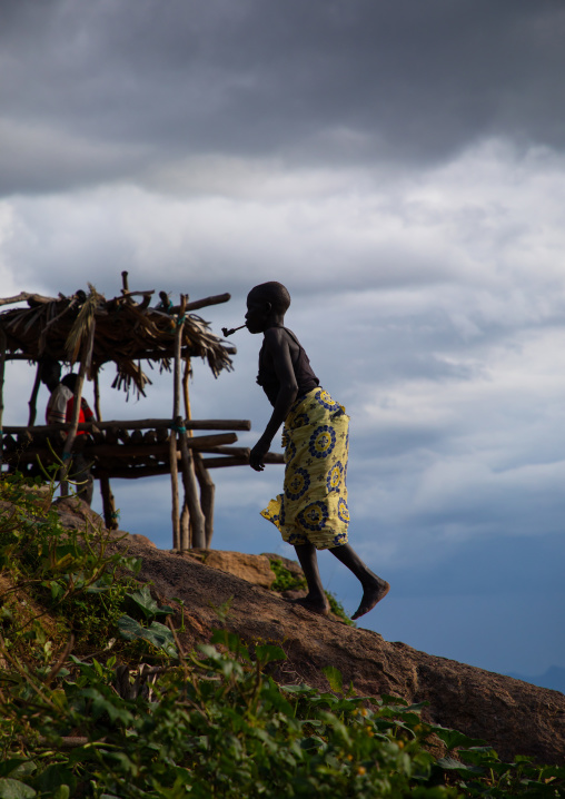 Lotuko trive woman smoking a pipe, Central Equatoria, Illeu, South Sudan