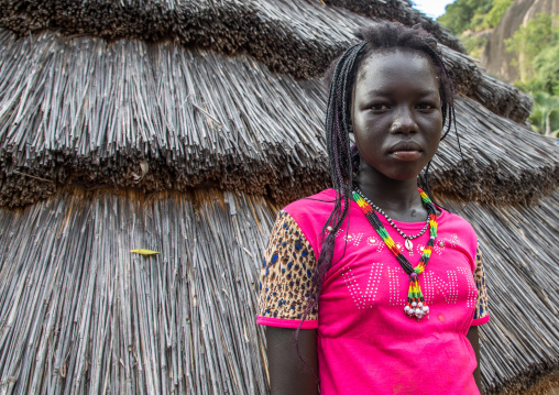 Woman in front of a Lotuko tribe thatched house, Central Equatoria, Illeu, South Sudan