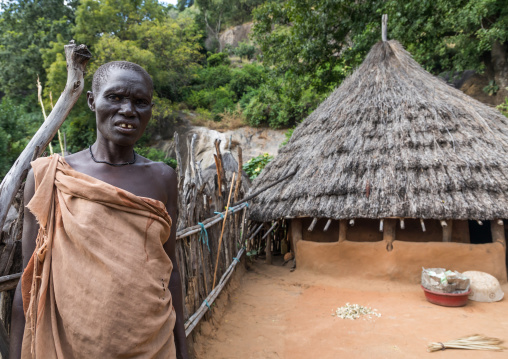 Woman in front of a Lotuko tribe thatched house, Central Equatoria, Illeu, South Sudan