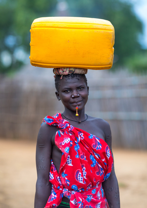 Portrait of a Larim tribe woman carrying a yellow jerrican on the head, Boya Mountains, Imatong, South Sudan