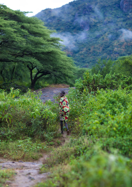 Larim tribe woman on a small path, Boya Mountains, Imatong, South Sudan