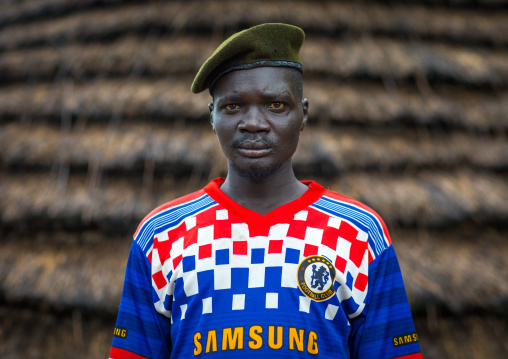 Portrait of a former soldier from Larim tribe wearing a chelsea football shirt, Boya Mountains, Imatong, South Sudan