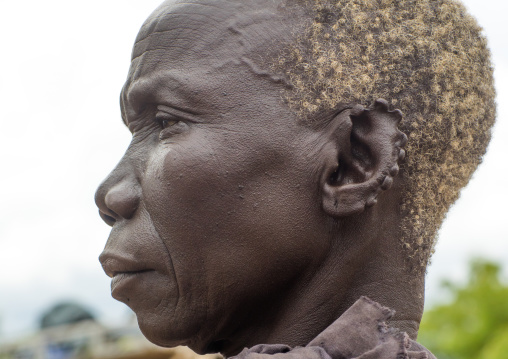 Lotuko tribe old woman with the ears cut in the same way they do to their cows as decoration, Central Equatoria, Illeu, South Sudan