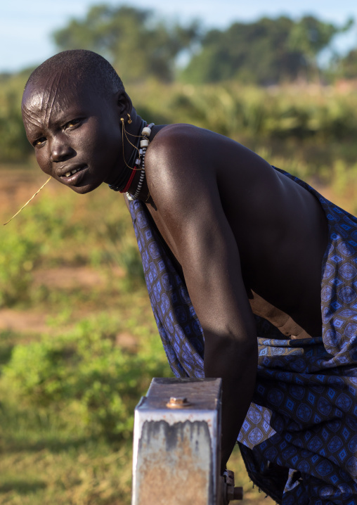 Mundari tribe woman pumping water in a well, Central Equatoria, Terekeka, South Sudan