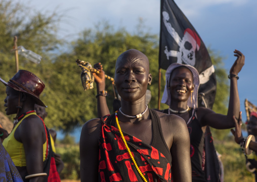 Mundari tribe women with a pirate flag while celebrating a wedding, Central Equatoria, Terekeka, South Sudan