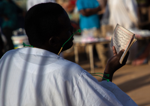 Sudanese man reading the quran during the friday sufi celebration at sheikh Hamad el Nil tomb, Khartoum State, Omdurman, Sudan