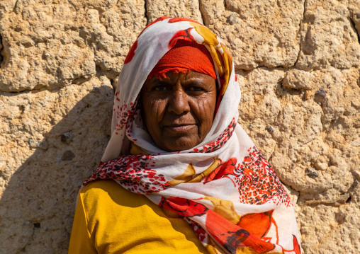 Bisharin nomad woman collecting salt in Atrun crater, Bayuda desert, Atrun, Sudan