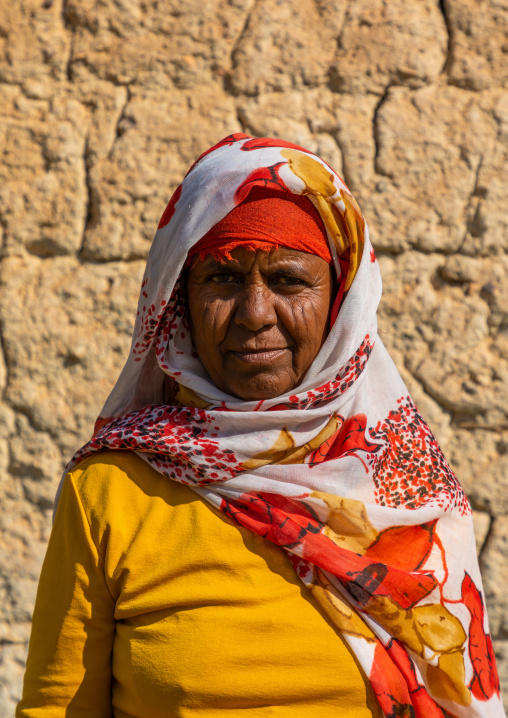 Bisharin nomad woman collecting salt in Atrun crater, Bayuda desert, Atrun, Sudan